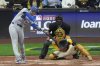 Los Angeles Dodgers' Freddie Freeman hits a single during the ninth inning of Game 2 of baseball's National League Championship Series against the Milwaukee Brewers Tuesday, Oct. 14, 2025, in Milwaukee. (AP Photo/Morry Gash)