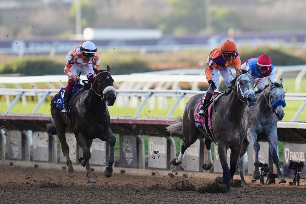 John Velazquez rides Ted Noffey, center, to victory past Flavien Prat, riding Brant, right, and Antonio Fresu, riding Mr. A.P., left, in the Breeders' Cup Juvenile horse race in Del Mar, Calif., Friday, Oct. 31, 2025. (AP Photo/Gregory Bull)