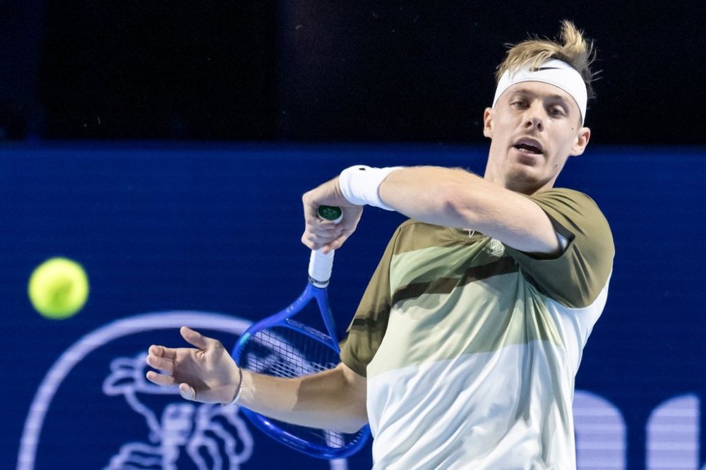 Canada's Denis Shapovalov returns a ball to Brazil's Joao Fonseca during their quarterfinal match at the Swiss Indoors tennis tournament at the St. Jakobshalle in Basel, Switzerland, Friday, Oct. 24, 2025. (Georgios Kefalas/Keystone via AP)