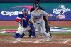 Los Angeles Dodgers' Will Smith follows through on an RBI fielder's choice against the Toronto Blue Jays during the eighth inning in Game 2 of baseball's World Series, Saturday, Oct. 25, 2025, in Toronto. (AP Photo/David J. Phillip)