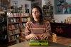 Chawa Magaña, owner of Palabras Bilingual Bookstore, poses with a few of her favorite books Monday, Oct. 6, 2025, in Phoenix. (AP Photo/Ross D. Franklin)