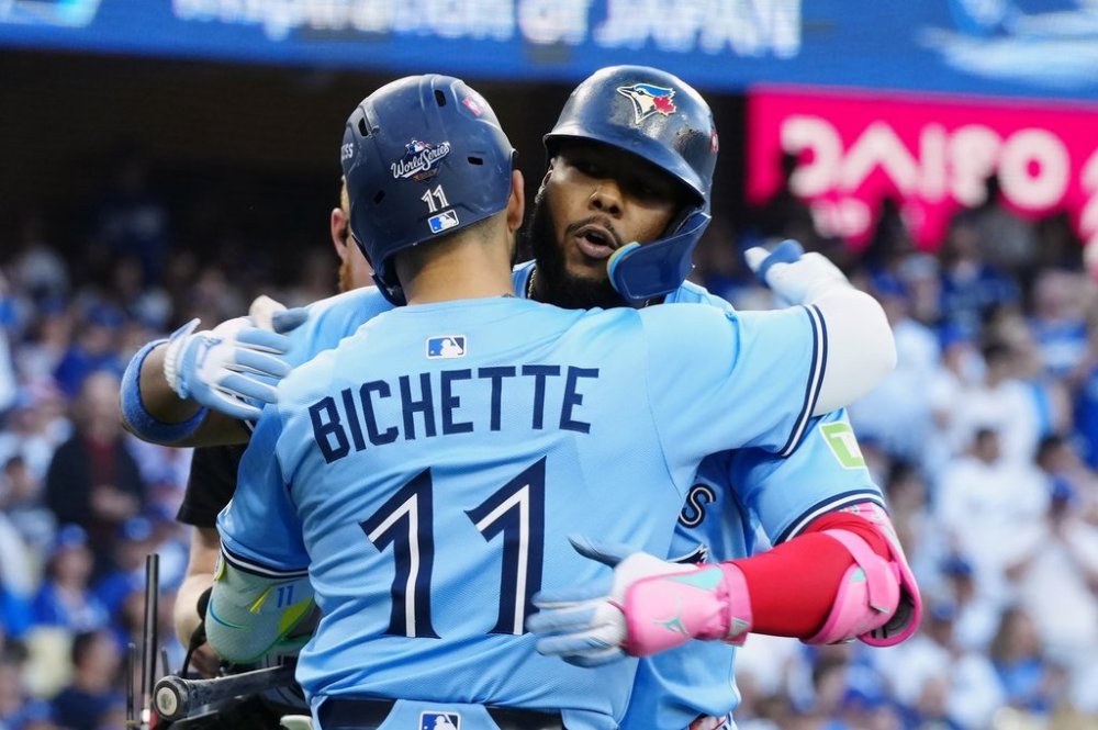 Toronto Blue Jays' Vladimir Guerrero Jr. (27) celebrates his solo home run against the Los Angeles Dodgers with Bo Bichette (11) during first inning Game 5 World Series playoff MLB baseball action in Los Angeles on Wednesday, Oct. 29, 2025. THE CANADIAN PRESS/Frank Gunn
