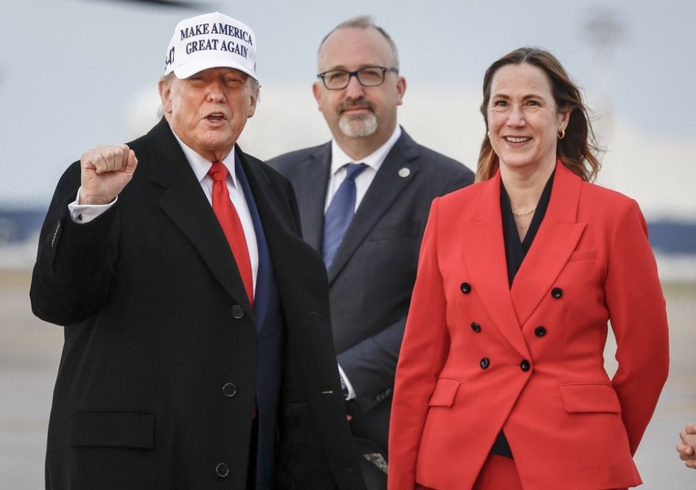 U.S. President Donald Trump, left, pumps his fist as he is greeted by Kirsten Hillman, Canadian ambassador to the United States, right, as he arrives in Calgary, Alta., Sunday, June 15, 2025, to attend the G7 Leaders meeting in Kananaskis. THE CANADIAN PRESS/Jeff McIntosh