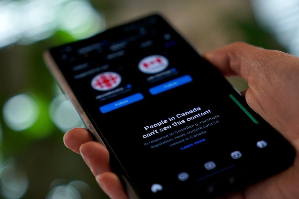A smartphone showing Meta's block on Canadian news content is shown in a photo illustration in Toronto on Thursday, Aug. 1, 2024. THE CANADIAN PRESS/Giordano Ciampini