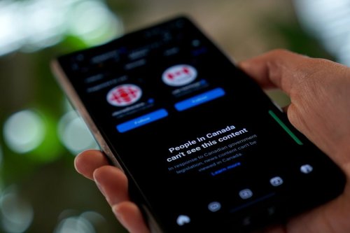 A smartphone showing Meta's block on Canadian news content is shown in a photo illustration in Toronto on Thursday, Aug. 1, 2024. THE CANADIAN PRESS/Giordano Ciampini
