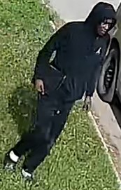 SUPPLIEDThe surveillance pictures show him wearing a black hoodie with a logo on the chest, black shoes and white socks.