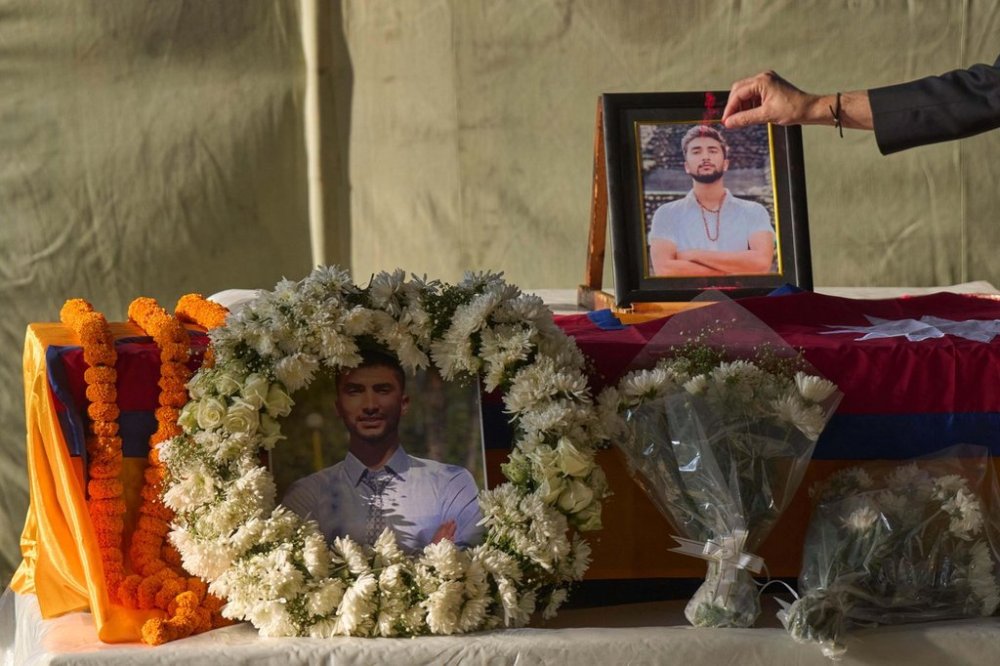 A Nepalese man pays his respects to Bipin Joshi, a Nepali man who was taken hostage by Hamas, during a memorial procession at Tribhuvan International Airport in Kathmandu, Nepal, Monday, Oct. 20, 2025. (AP Photo/Niranjan Shrestha)