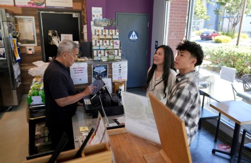 FILE - Braxton Kimura, right, orders food with his mother Carol Kimura at Vitality Bowl on Aug. 13, 2025, in San Jose, Calif. (AP Photo/Terry Chea, File)