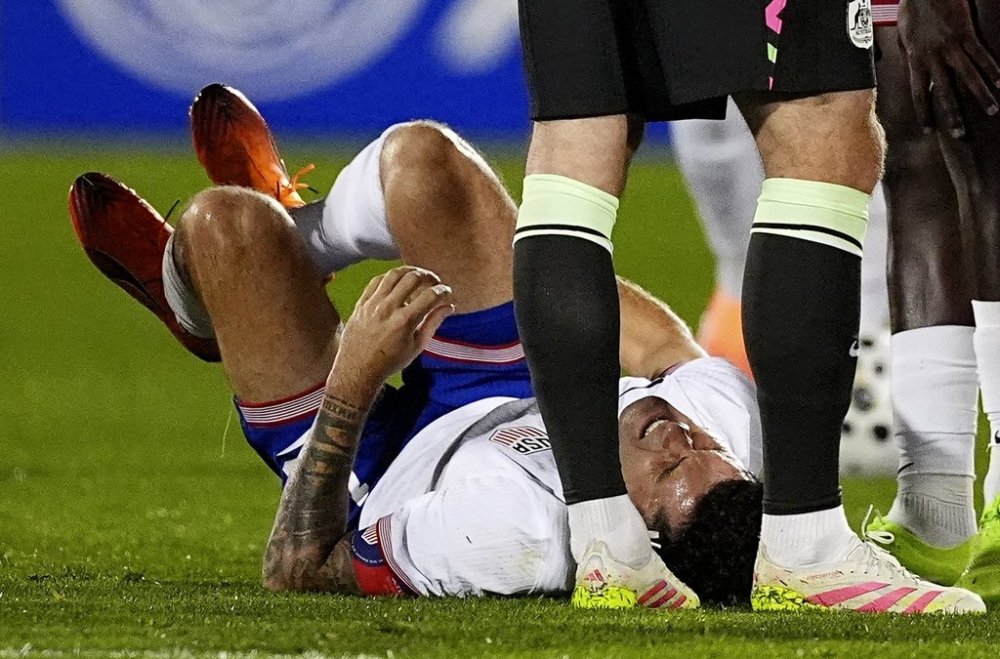 United States forward Chrisitan Pulisic reacts after being injured against Australia in the first half of an international friendly soccer match Tuesday, Oct. 14, 2025, in Commerce City, Colo. (AP Photo/David Zalubowski)