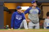 Chicago Cubs manager Craig Counsell, left, and bench coach Ryan Flaherty, right, look on from the dugout during the seventh inning of Game 5 of baseball's National League Division Series against the Milwaukee Brewers, Saturday, Oct. 11, 2025, in Milwaukee. (AP Photo/Kayla Wolf)
