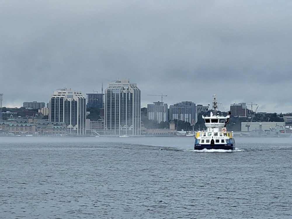 A passenger ferry operated by Halifax Transit makes its way across the Halifax harbour to the Woodside ferry terminal in Dartmouth, N.S., on Tuesday, Aug. 2, 2022.  THE CANADIAN PRESS/Doug Ives