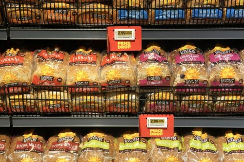 Signs advertise a price drop on bread at a No Frills Grocery store, in Toronto, on Thursday, May 30, 2024. THE CANADIAN PRESS/Chris Young