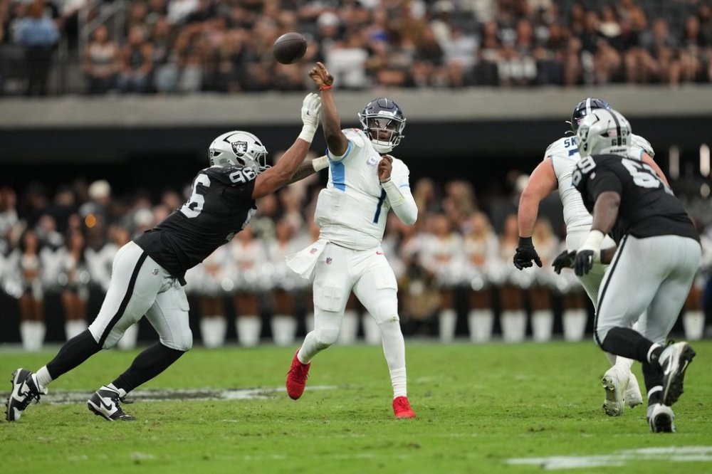 Las Vegas Raiders defensive tackle Jonah Laulu (96) pressures Tennessee Titans quarterback Cam Ward (1) during the first half of an NFL football game, Sunday, Oct. 12, 2025, in Las Vegas. (AP Photo/Rick Scuteri)