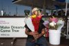 FILE - Flower vendor Jose, an immigrant from Mexico, sits for a photo with his face covered by flowers outside a gas station in Los Angeles, Friday, Aug. 8, 2025. (AP Photo/Jae C. Hong, File)