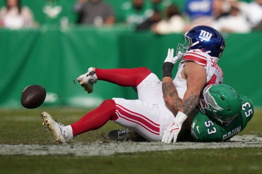 New York Giants running back Cam Skattebo (44) is injured near Philadelphia Eagles linebacker Zack Baun (53) during the first half of an NFL football game Sunday, Oct. 26, 2025, in Philadelphia. (AP Photo/Matt Slocum)