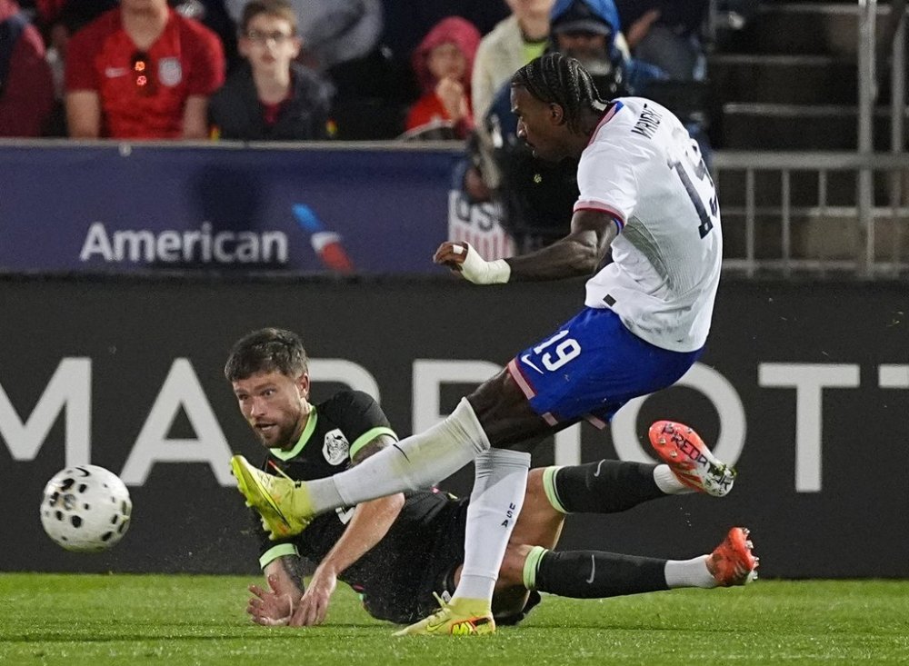 United States forward Haji Wright, front, kicks the ball for a goal as Australia defender Cameron Burgess covers in the second half of an international friendly soccer match Tuesday, Oct. 14, 2025, in Commerce City, Colo.(AP Photo/David Zalubowski)