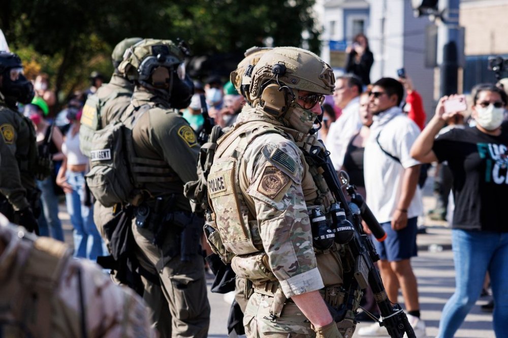 Federal officers stand guard in the Brighton Park neighborhood of Chicago, on Saturday, Oct. 4, 2025, after protesters learned that U.S. Border Patrol shot a woman Saturday morning on Chicago's Southwest Side. (Anthony Vazquez/Chicago Sun-Times via AP)