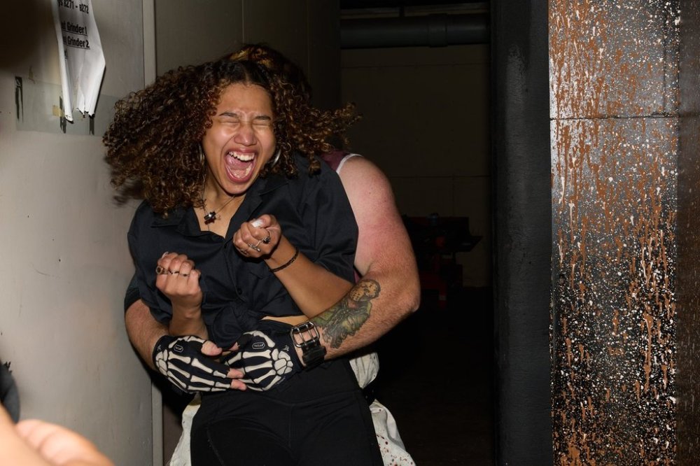 Rosey Washington reacts while being grabbed during her performance at the Erebus Haunted House, Oct. 2, 2025, in Pontiac, Mich. (AP Photo/Ryan Sun)