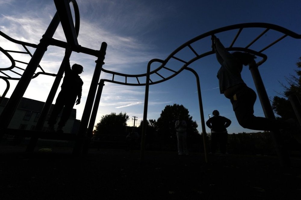 Children play on the monkey bars outside Funston Elementary School as night falls, in Chicago's Logan Square neighborhood, Thursday, Oct. 16, 2025. (AP Photo/Rebecca Blackwell)