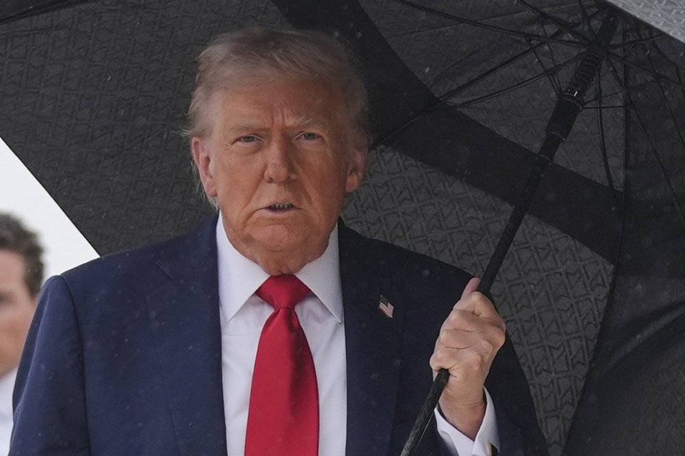 President Donald Trump walks over to speak with reporters before boarding Air Force One, Sunday, Oct. 12, 2025, at Joint Base Andrews, Md., as he heads to the Middle East. (AP Photo/Evan Vucci)