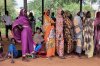 FILE - Women wait for cash assistance and dry grain from the U.N. World Food Program in Gendrassa refugee camp, Maban, South Sudan, on Aug. 20, 2025. (AP Photo/Caitlin Kelly, File)