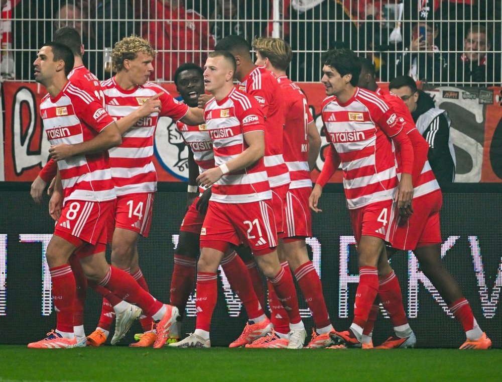 Union players celebrate after their first goal during the German Bundesliga soccer match between 1. FC Union Berlin and Borussia Moenchengladbach in Berlin, Friday, Oct. 17, 2025. (Soeren Stache/dpa via AP)