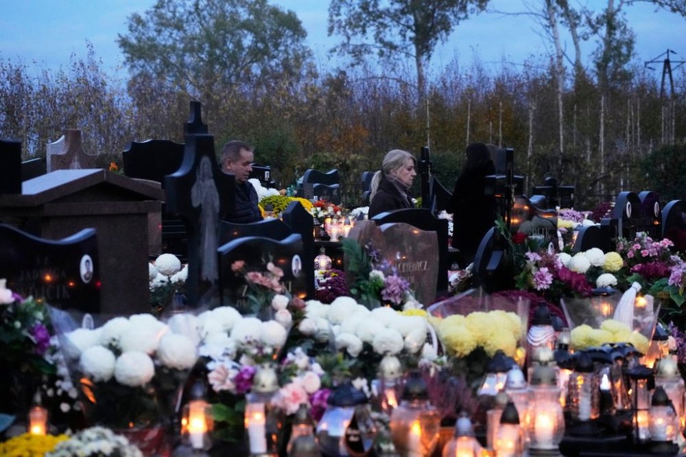 People mark All Saints' Day, a time of reflection for the dead, in Kroczewo near Warsaw, Poland, Saturday, November 1, 2025. (AP Photo/Czarek Sokolowski)