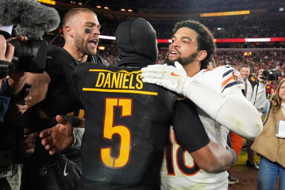 FILE - Washington Commanders quarterback Jayden Daniels (5) is congratulated by Chicago Bears quarterback Caleb Williams (18) after the Commanders won 18-15 in an NFL football game, Oct. 27, 2024, in Landover, Md. (AP Photo/Stephanie Scarbrough, File)
