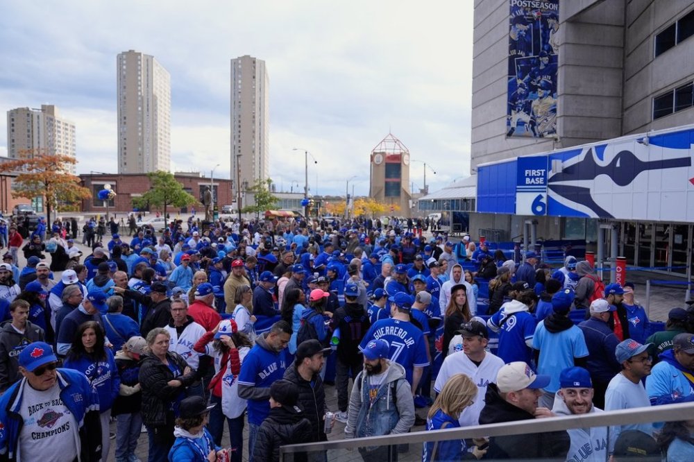 Fans arrive for Game 2 of baseball's World Series between the Los Angeles Dodgers and the Toronto Blue Jays, in Toronto, Saturday, Oct. 25, 2025. THE CANADIAN PRESS/AP-Brynn Anderson