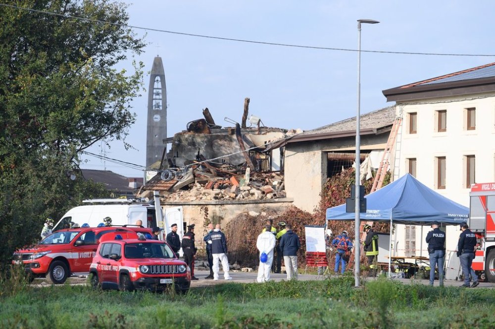 Rescuers inspect a collapsed two-story farmhouse in Castel d'Azzano, some 10 kilometers south-west of Verona, where three carabinieri officers have been killed, and 13 others injured, in an explosion during an eviction, early Tuesday, Oct. 14, 2025. (Claudio Furlan/LaPresse via AP)
