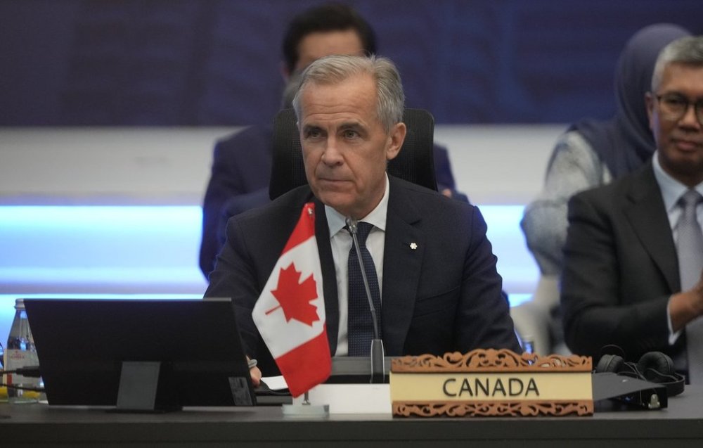 Prime Minister Mark Carney waits for a plenary session to begin at the ASEAN summit in Kuala Lumpur, Malaysia, Sunday Oct. 26, 2025. THE CANADIAN PRESS/Adrian Wyld