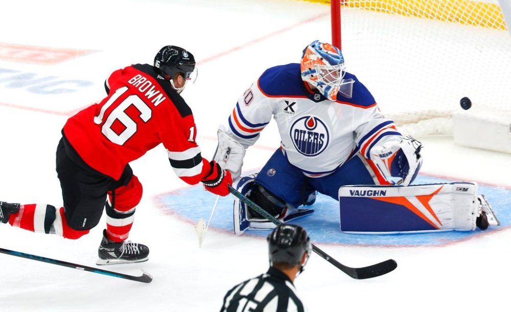 New Jersey Devils right wing Connor Brown (16) scores a goal against Edmonton Oilers goaltender Calvin Pickard (30) during the third period of an NHL hockey game, Saturday, Oct. 18, 2025, in Newark, N.J. (AP Photo/Noah K. Murray)