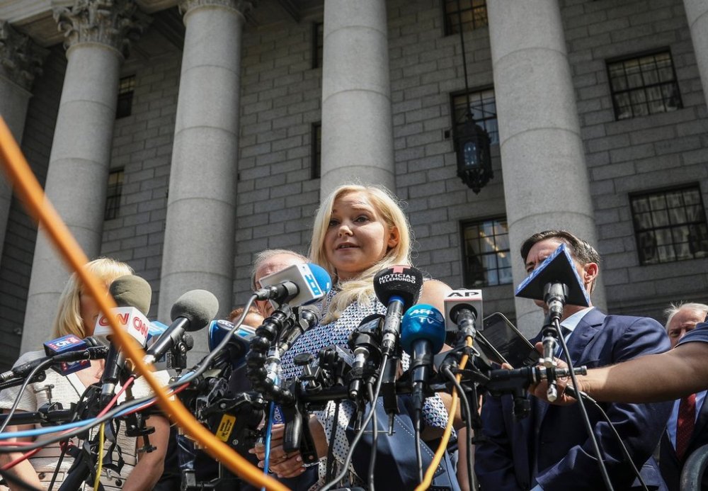 FILE - Virginia Roberts Giuffre, center, who says she was trafficked by sex offender Jeffrey Epstein, holds a news conference outside a Manhattan court where sexual assault claimants invited by a judge addressed a hearing following Epstein's jailhouse death in New York, Aug. 27, 2019. (AP Photo/Bebeto Matthews, File)
