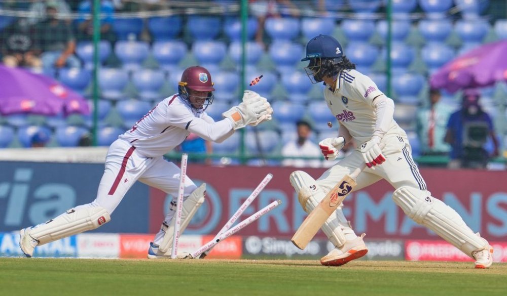 West Indies' wicketkeeper Tevin Imlach takes the bails off of India's KL Rahul, right, on the first day of the second cricket test match between India and West Indies at the Arun Jaitley Stadium in New Delhi, India, Friday, Oct.10, 2025. (AP Photo/Manish Swarup)