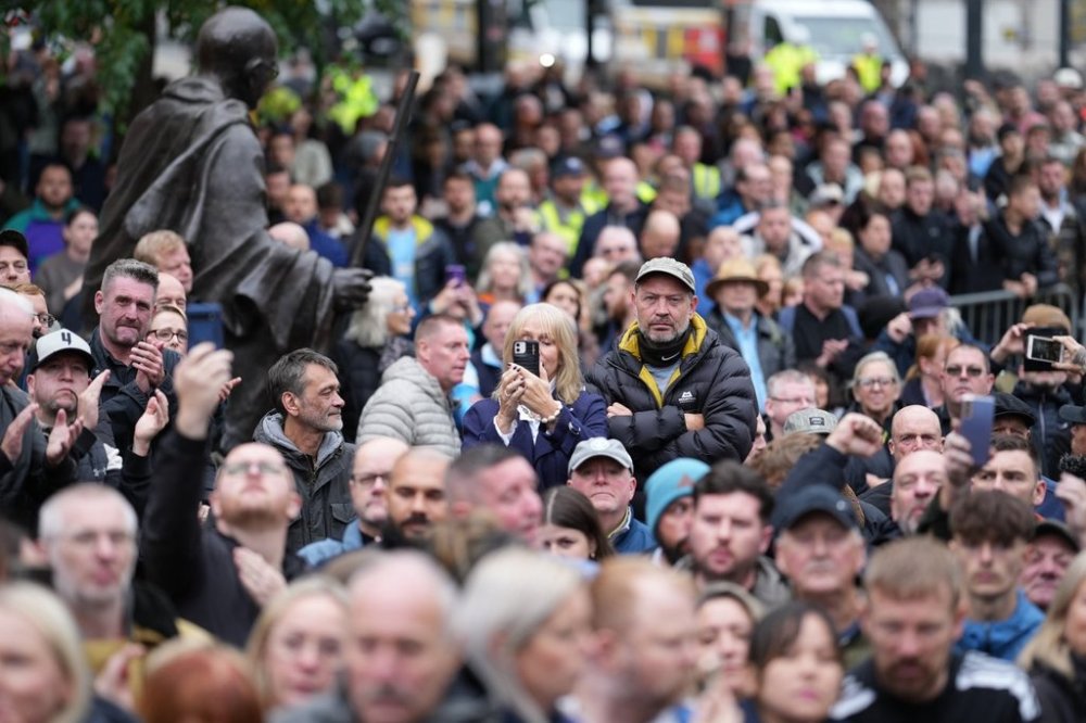 Crowds gather outside Manchester Cathedral during the funeral for boxer Ricky Hatton in Manchester, England, Friday, Oct. 10, 2025. (AP Photo/Jon Super)