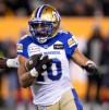 Winnipeg Blue Bombers wide receiver Nic Demski (10) runs the ball as Montreal Alouettes defensive end Shawn Lemon (0) defends during the first half of the 110th CFL Grey Cup in Hamilton, Ont., on Sunday, November 19, 2023. THE CANADIAN PRESS/Nathan Denette