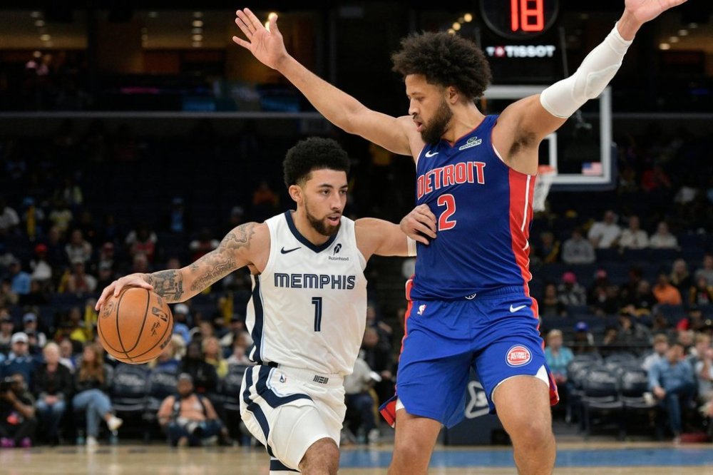 Memphis Grizzlies guard Scotty Pippen Jr. (1) handles the ball against Detroit Pistons guard Cade Cunningham (2) in the first half of an NBA basketball preseason game Monday, Oct. 6, 2025, in Memphis, Tenn. (AP Photo/Brandon Dill)
