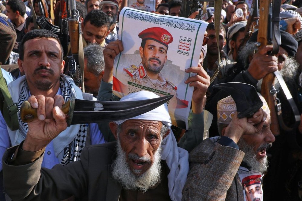 Houthi supporters hold a poster of Maj. Gen. Muhammad Abdul Karim al-Ghamari, who died of wounds he suffered after an Israeli attack, during an anti-U.S. and anti-Israel rally in Sanaa, Yemen, Friday, Oct. 17, 2025. (AP Photo/Osamah Abdulrahman)