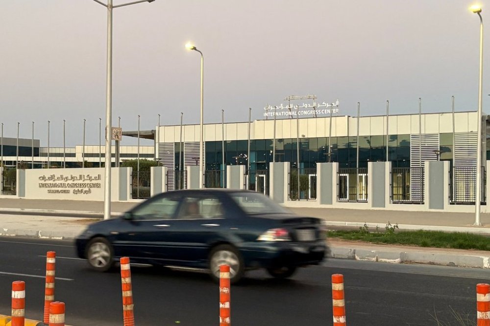A vehicle passes in front of the International Conference Center where Israeli and Hamas officials are set to hold indirect talks Wednesday, Oct. 8, 2025. (AP Photo)