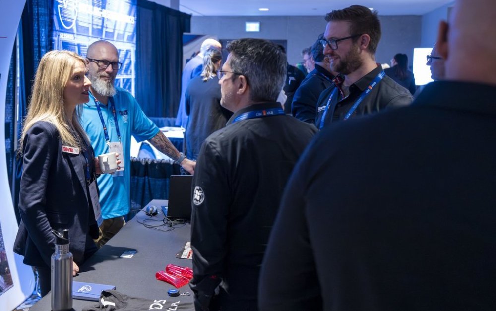 Veronique Roy, left, president of Logiciel Magnus speaks with attendees at the Canadian Steel Conference in Montreal on Tuesday, Oct. 28, 2025. THE CANADIAN PRESS/Christinne Muschi
