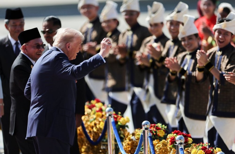U.S. President Donald Trump reacts to dancing performers during a welcoming ceremony after arriving at Kuala Lumpur International Airport, to attend the 47th Association of Southeast Asian Nations (ASEAN) summit in Kuala Lumpur, Malaysia, Sunday, Oct. 26, 2025. (Hasnoor Hussain/Pool Photo via AP)