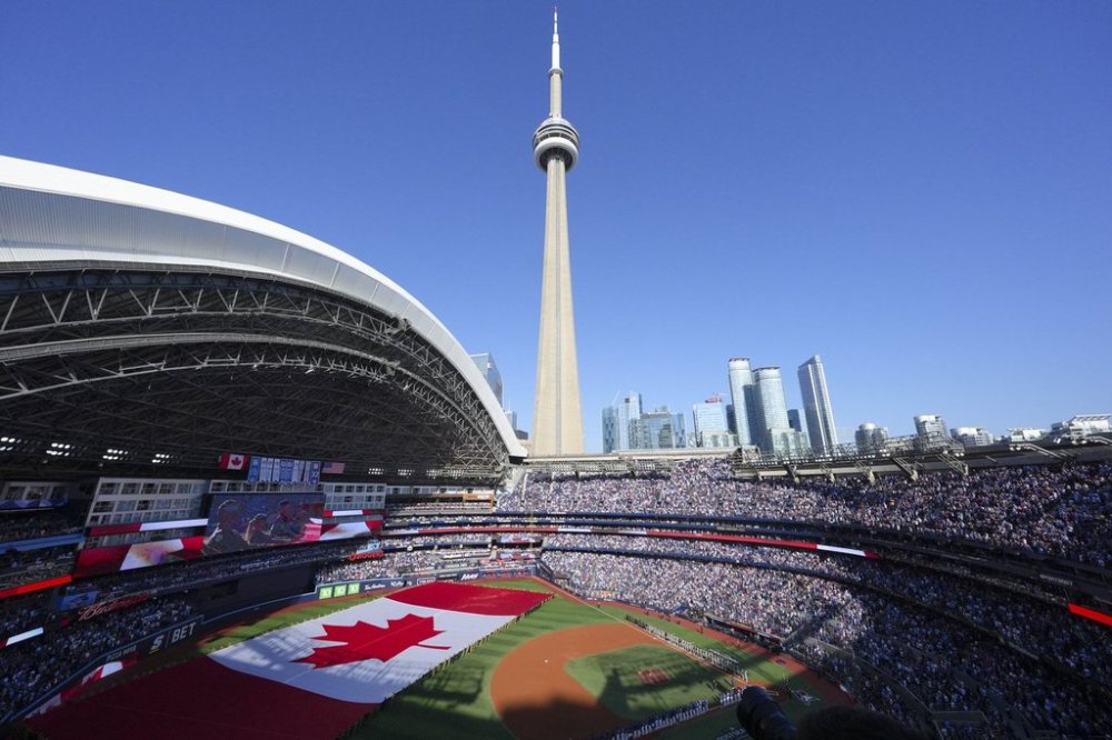 The Canadian flag is displayed on the field during an anthems ceremony ahead of the start of the American League Division Series MLB playoff series between the Toronto Blue Jays and the New York Yankees in Toronto on Saturday, October 4, 2025. THE CANADIAN PRESS/Chris Young