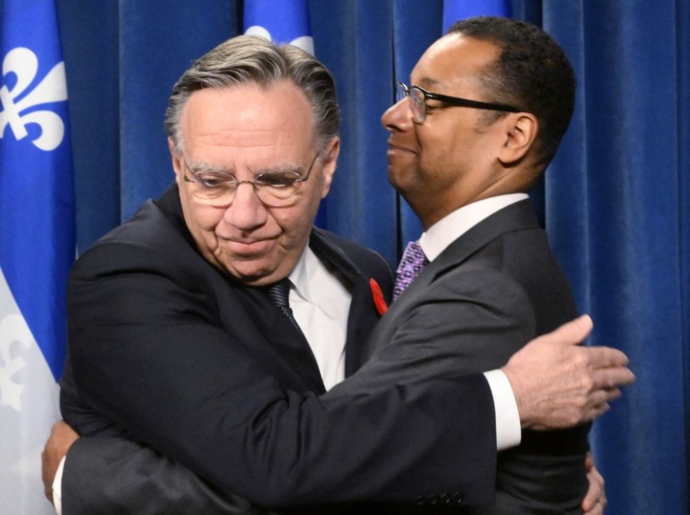 Quebec Premier François Legault, left, hugs Quebec Social Services Minister Lionel Carmant, who has announced his decision to resign as minister and sit as an Independent, at the legislature in Quebec City, Thursday, Oct. 30, 2025  THE CANADIAN PRESS/Jacques Boissinot