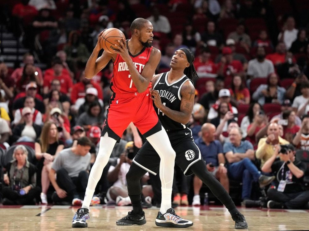 Houston Rockets forward Kevin Durant (7) controls the ball against Brooklyn Nets guard Terance Mann, right, during the first half of an NBA basketball game, Monday, Oct. 27, 2025, in Houston. (AP Photo/Karen Warren)
