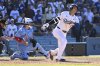 Los Angeles Dodgers' Shohei Ohtani strikes out with the bases loaded during the ninth inning of a baseball game against the Toronto Blue Jays, Sunday, Aug. 10, 2025, in Los Angeles. (AP Photo/Wally Skalij)