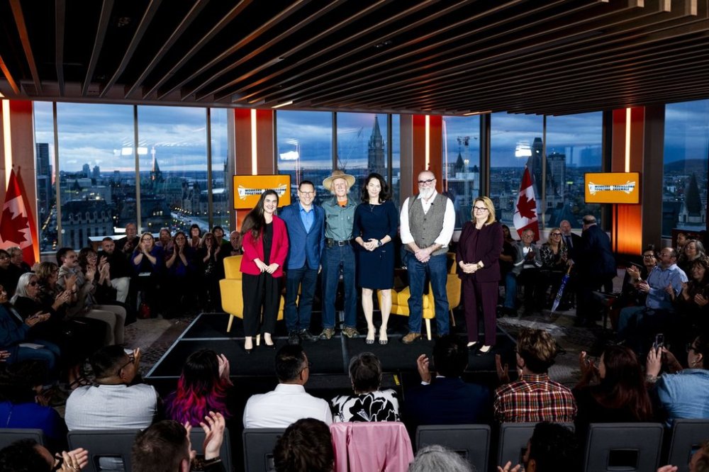 NDP Leadership Candidates, left to right, Tanille Johnston, Avi Lewis, Tony McQuail, Heather McPherson, Rob Ashton and President of the Canadian Labour Congress (CLC) Bea Bruske pose for a family photo ahead of the NDP Leadership forum in Ottawa, on Wednesday, Oct. 22, 2025. THE CANADIAN PRESS/Spencer Colby