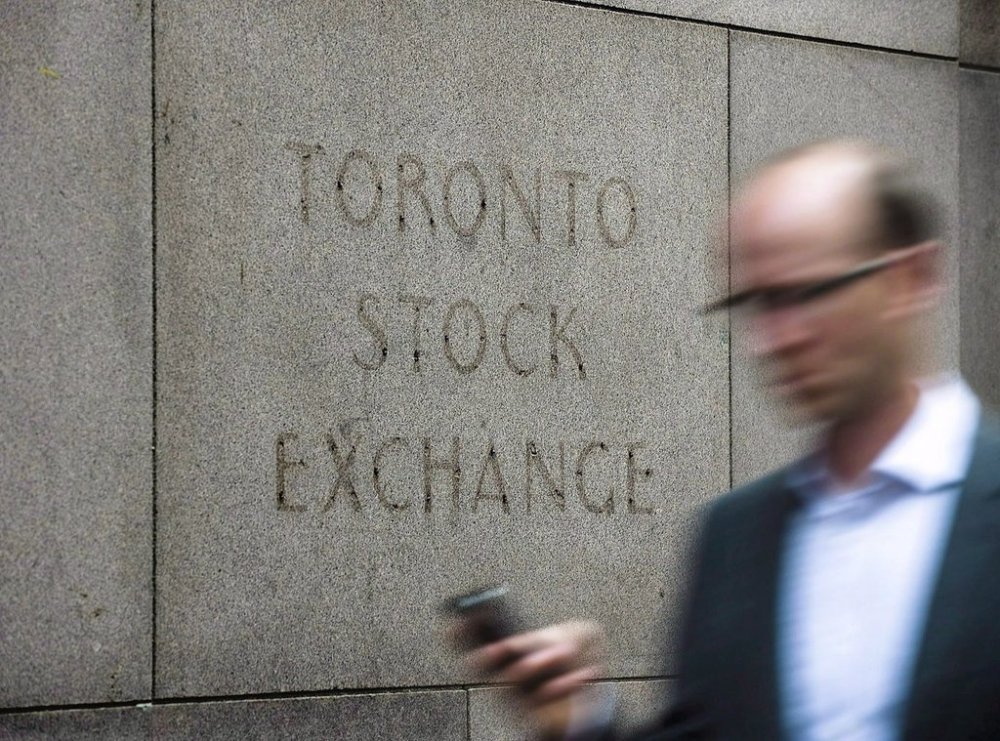 A man walks past a building in Toronto that used to house the Toronto Stock Exchange on Aug. 18, 2011.THE CANADIAN PRESS/Aaron Vincent Elkaim