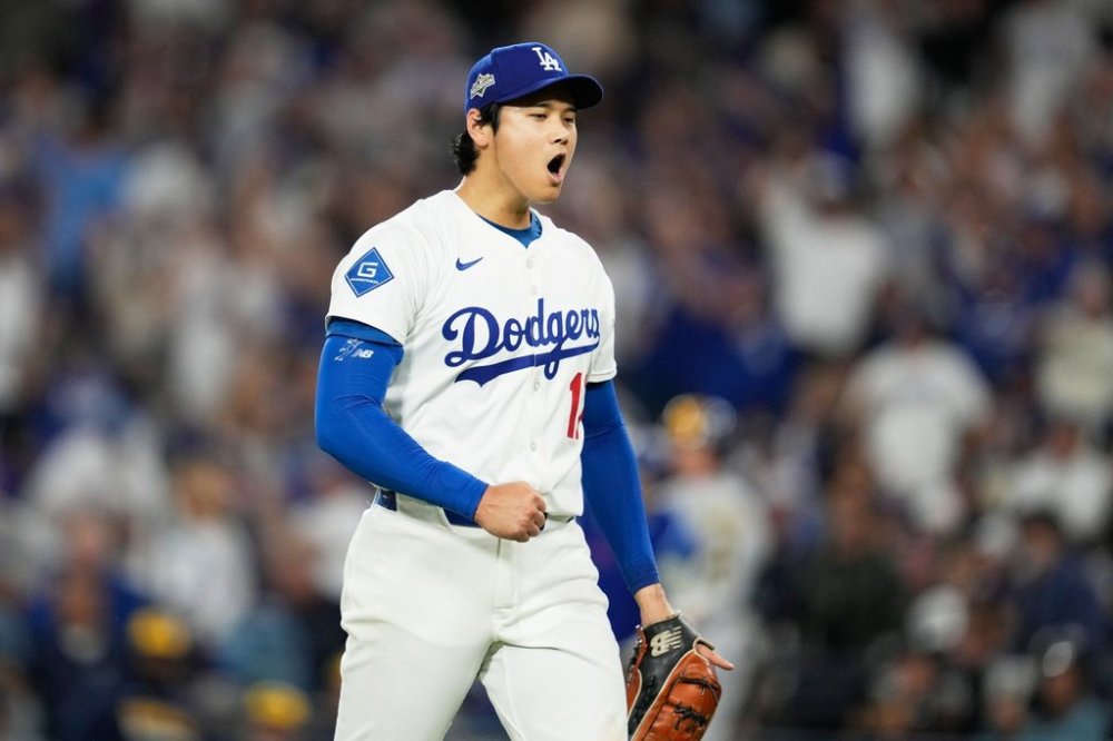 Los Angeles Dodgers pitcher Shohei Ohtani celebrates the end of the top of the third inning against the Milwaukee Brewers in Game 4 of baseball's National League Championship Series, Friday, Oct. 17, 2025, in Los Angeles. (AP Photo/Ashley Landis)