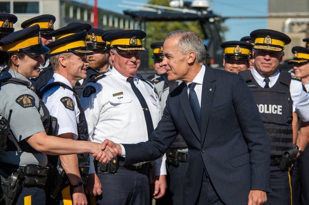 Prime Minister Mark Carney visits an RCMP detachment to make an announcement in Etobicoke, Ont., on Thursday, Oct. 16, 2025. THE CANADIAN PRESS/Laura Proctor