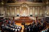 FILE - Members of opposition parties stand to vote against a government confidence motion at the Portuguese parliament in Lisbon, Tuesday, March 11, 2025. (AP Photo/Armando Franca, file)